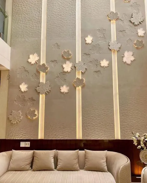 Luxury double-height living room featuring an expansive floor-to-ceiling CNC carved natural stone accent wall by Stone World