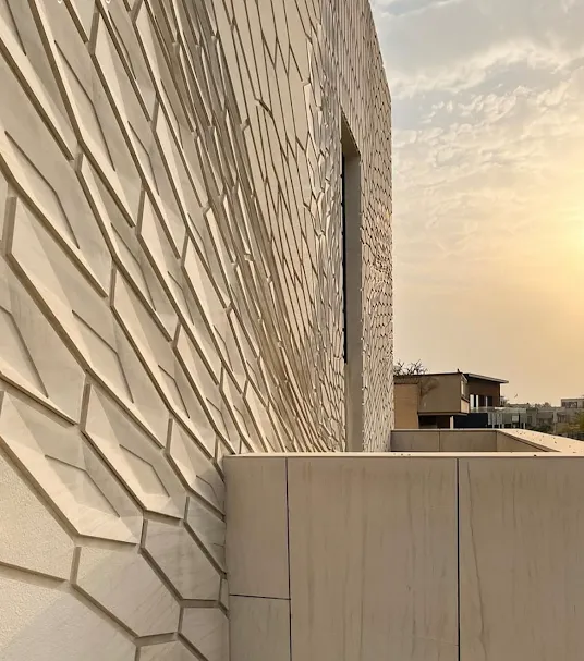 Exterior facade featuring textured CNC carved natural stone elevation highlights by Stone World