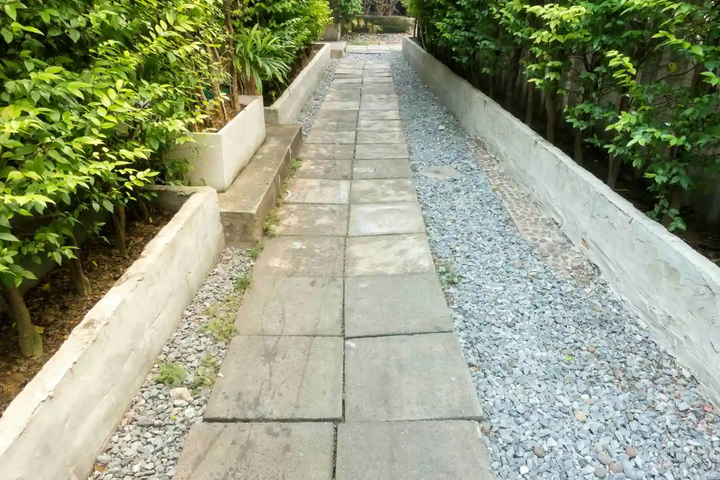 Garden designs with stones - stone pathway through lush garden